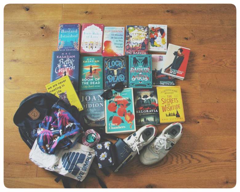 Books, shoes, a backpack, shirts, and several other items lying on the ground – my low buy summer didn't go as planned