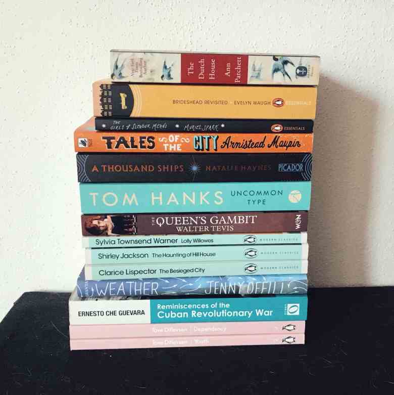 a pile of books on a shelf that proves that life after low buy is once again a bookish one